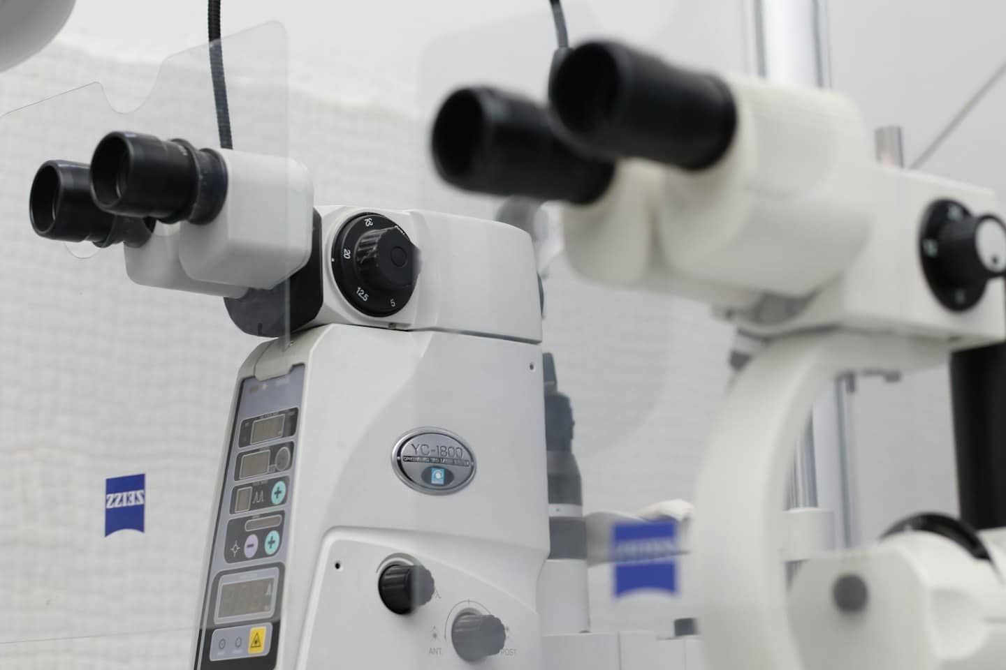 Ophthalmic diagnostic slit lamp with digital display and control dials.