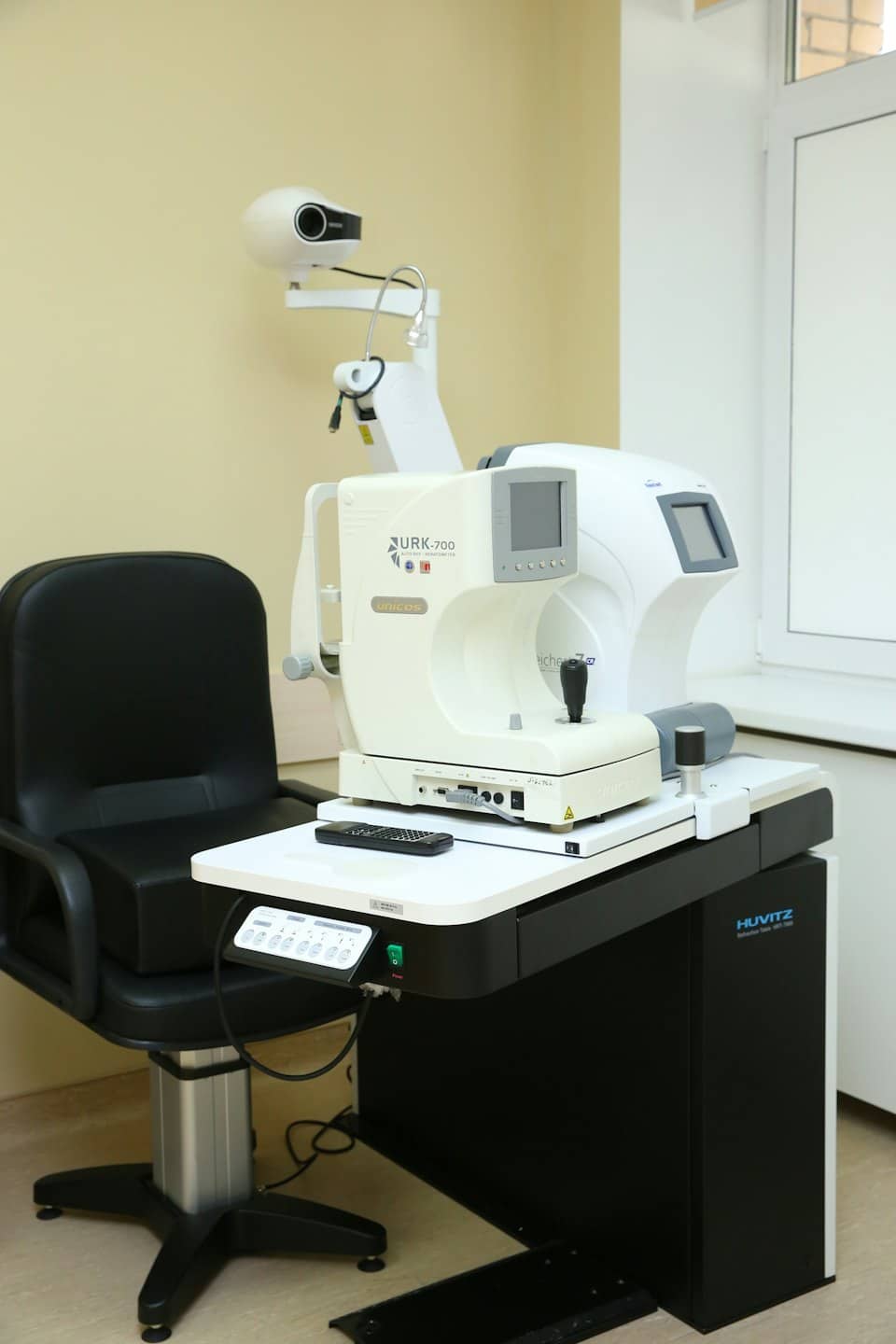 Ophthalmology exam chair and refractometer equipment in a clinic.